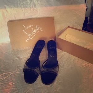 Louboutin black mesh slides.
